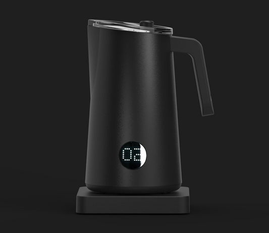 A black NanoFoamer PRO milk frother on a dark background, displaying a digital readout of temperature